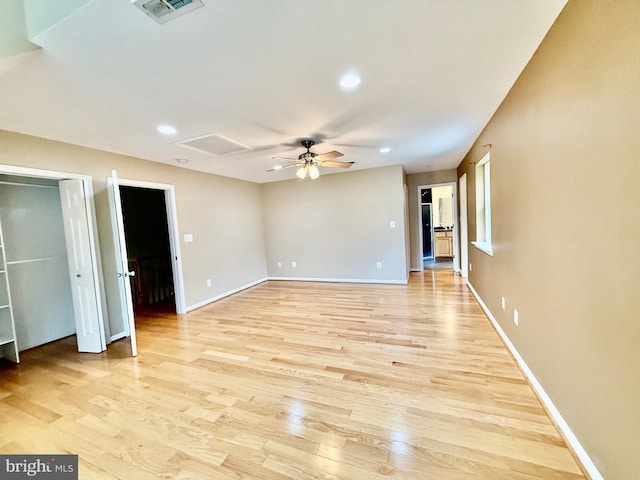 empty room with light wood-style flooring, attic access, baseboards, recessed lighting, and a ceiling fan