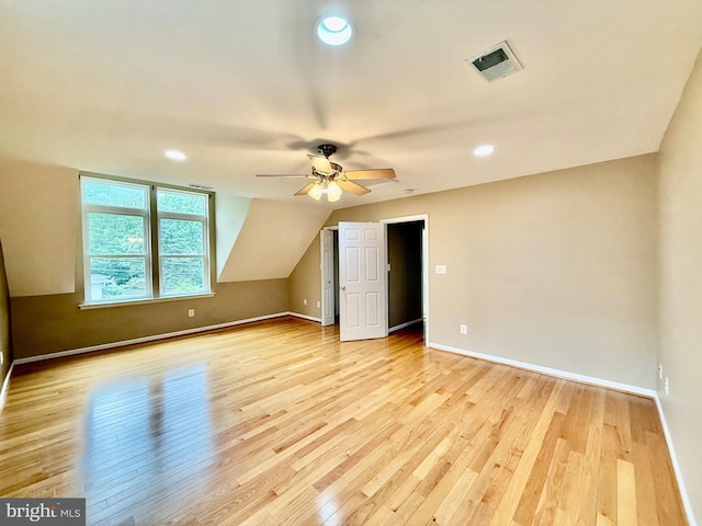 bonus room with light wood-style flooring, ceiling fan, baseboards, recessed lighting, and lofted ceiling