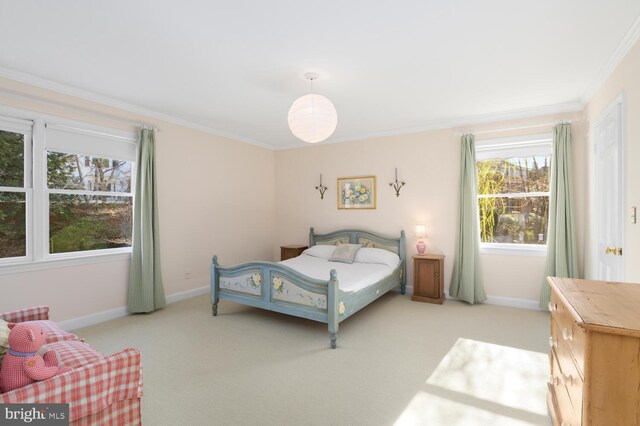 bedroom with crown molding, light colored carpet, and baseboards