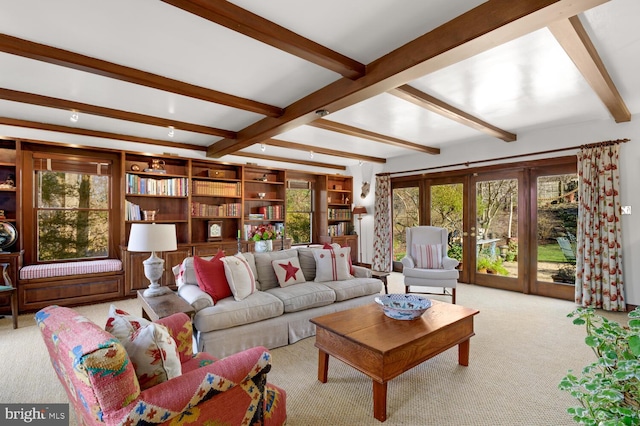 living room featuring beam ceiling, carpet, and french doors