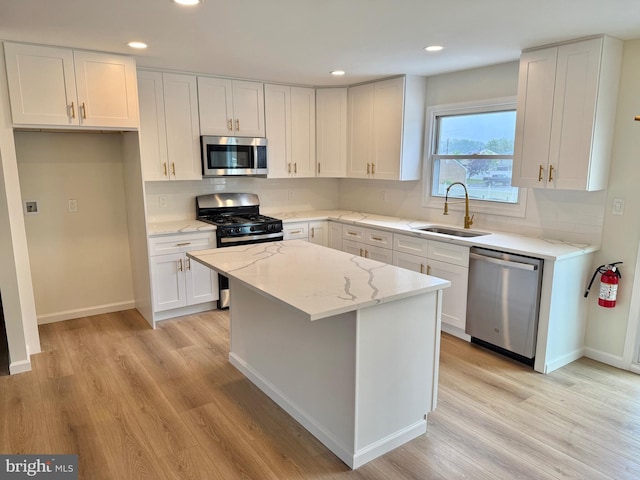 6 Spring Hill Dr, Clementon, NJ 08021 - kitchen featuring a sink, stainless steel appliances, light wood-type flooring, a kitchen island, and white cabinets