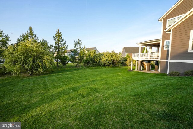 view of green lawn featuring stairs