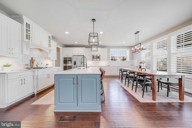 kitchen with stainless steel appliances, white cabinets, light countertops, tasteful backsplash, and recessed lighting