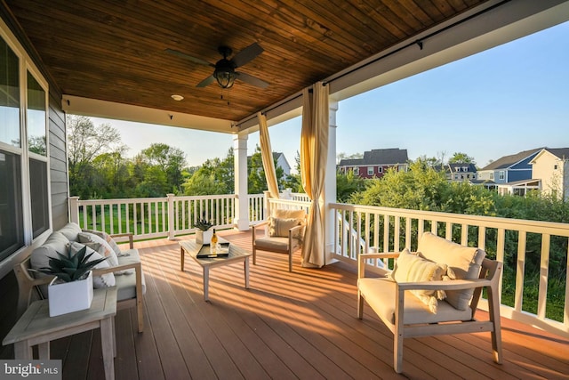 wooden terrace with ceiling fan and outdoor lounge area