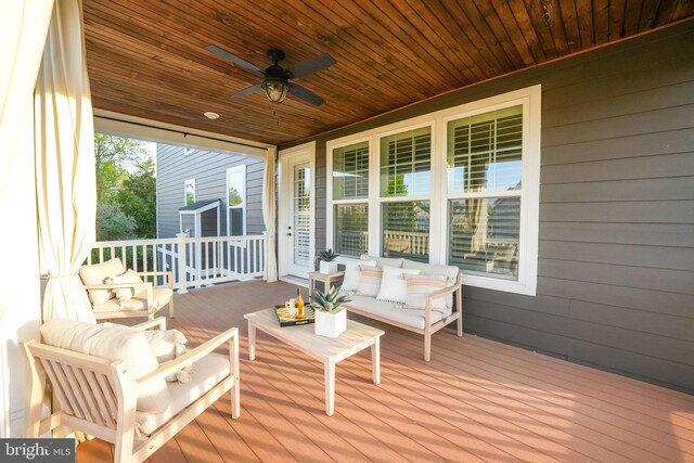 deck featuring ceiling fan and an outdoor living space