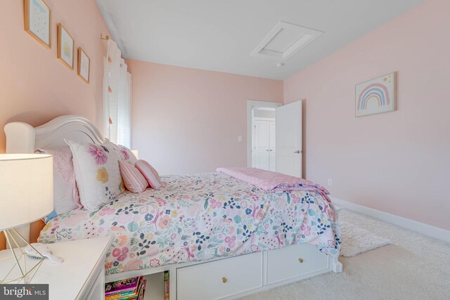 bedroom featuring attic access, carpet flooring, and baseboards