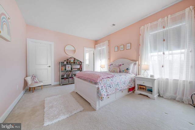 bedroom featuring light colored carpet and baseboards