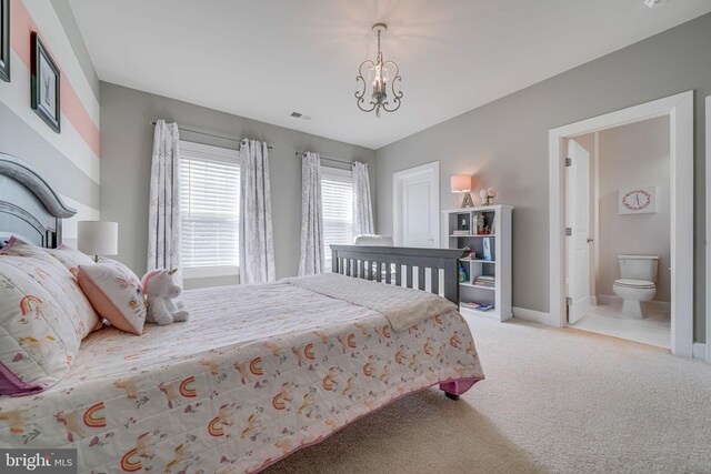 carpeted bedroom featuring a chandelier, baseboards, and ensuite bathroom