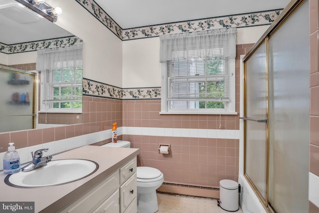 249 N Holly St, Elizabethtown, PA 17022 - bathroom featuring a baseboard radiator, vanity, tile walls, toilet, and wainscoting