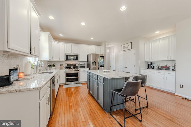 269 Bucktail Dr, Middletown, DE 19709 - kitchen with appliances with stainless steel finishes, white cabinets, a sink, gray cabinetry, and decorative backsplash