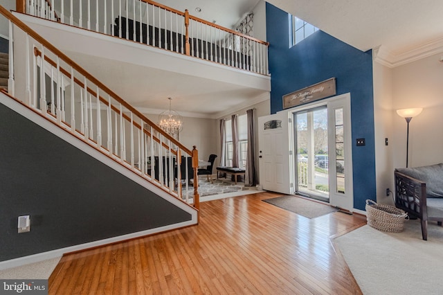 269 Bucktail Dr, Middletown, DE 19709 - entrance foyer featuring stairs, crown molding, a chandelier, a towering ceiling, and hardwood / wood-style floors