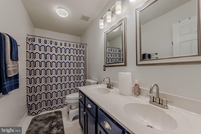 269 Bucktail Dr, Middletown, DE 19709 - bathroom featuring toilet, double vanity, and tile patterned floors