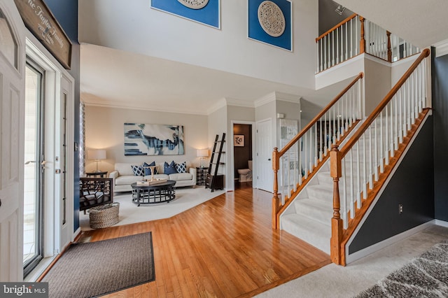 269 Bucktail Dr, Middletown, DE 19709 - entryway featuring stairs, crown molding, a high ceiling, healthy amount of natural light, and wood finished floors