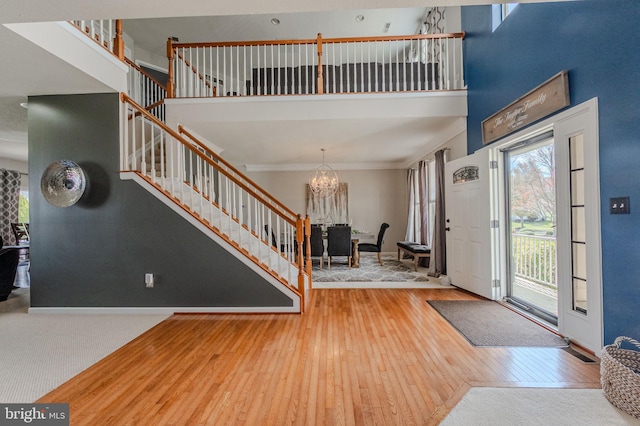 269 Bucktail Dr, Middletown, DE 19709 - entrance foyer with stairway, hardwood / wood-style floors, a chandelier, a high ceiling, and ornamental molding