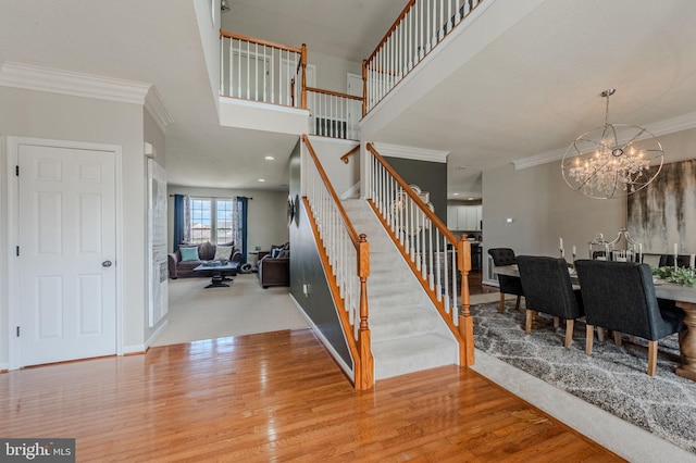 269 Bucktail Dr, Middletown, DE 19709 - stairs featuring a chandelier, ornamental molding, wood finished floors, and baseboards