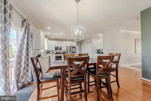 269 Bucktail Dr, Middletown, DE 19709 - dining space featuring baseboards, a chandelier, light wood-type flooring, recessed lighting, and crown molding