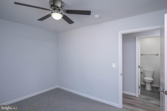 spare room featuring a ceiling fan, baseboards, and a smoke detector