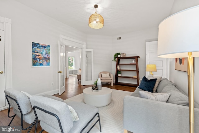 living area with wood finished floors and baseboards