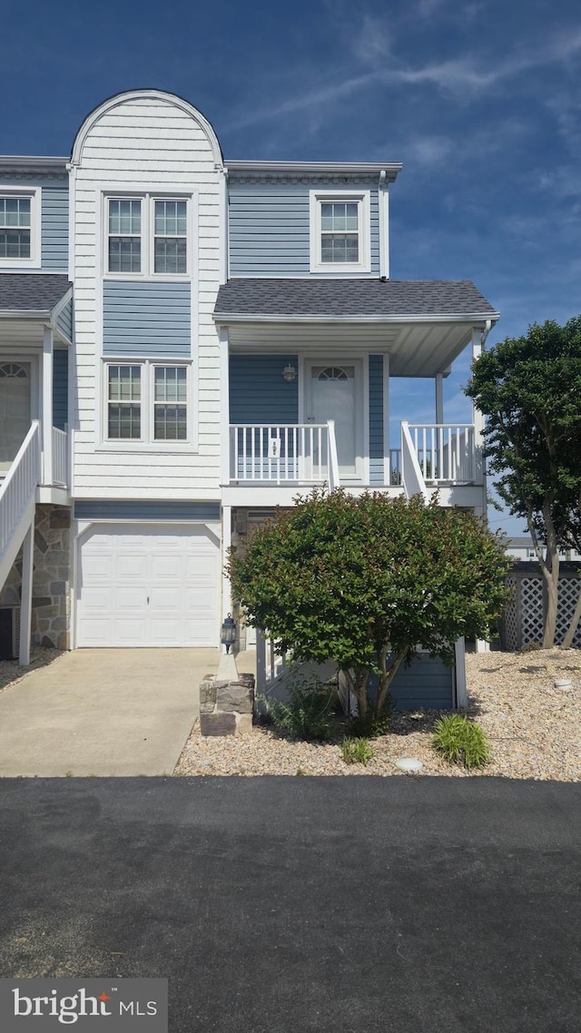 38261 Yacht Basin Rd Unit 35, Ocean View, DE 19970 - view of front of house with concrete driveway, an attached garage, roof with shingles, and stairs