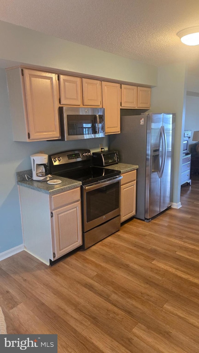 38261 Yacht Basin Rd Unit 35, Ocean View, DE 19970 - kitchen with stainless steel appliances, light wood finished floors, a textured ceiling, and dark countertops