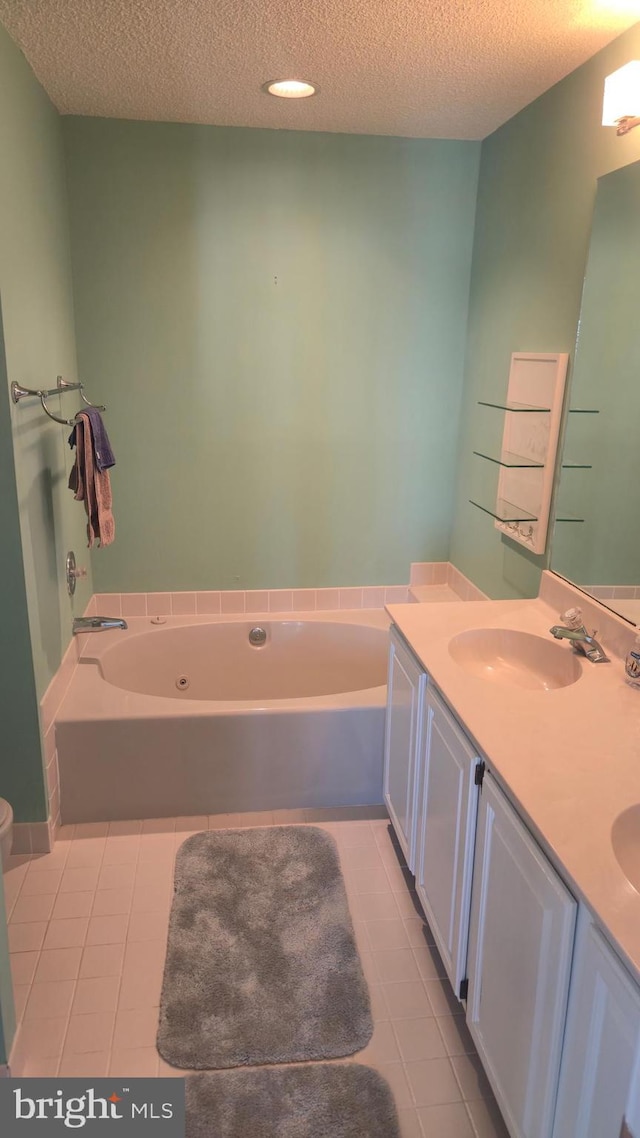 38261 Yacht Basin Rd Unit 35, Ocean View, DE 19970 - bathroom featuring tile patterned floors, a textured ceiling, a bath, and double vanity