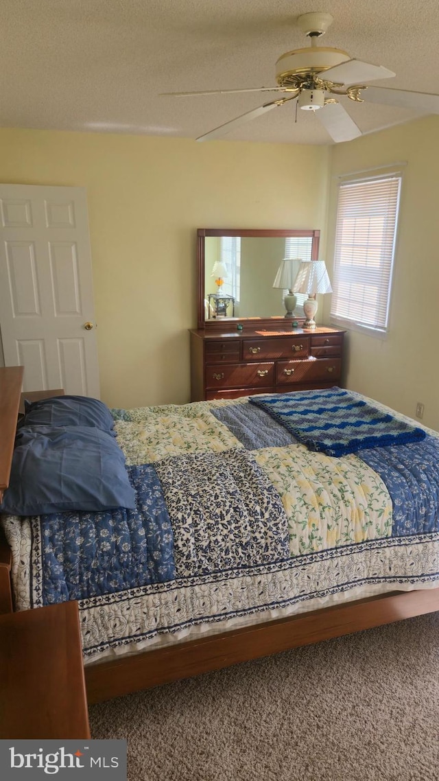 38261 Yacht Basin Rd Unit 35, Ocean View, DE 19970 - carpeted bedroom with a textured ceiling and ceiling fan