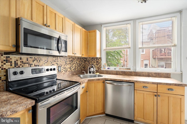 15 N Belnord Ave, Baltimore, MD 21224 - kitchen featuring stainless steel appliances, light brown cabinets, backsplash, light tile patterned flooring, and light countertops
