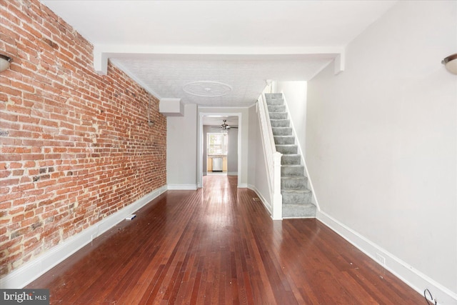 15 N Belnord Ave, Baltimore, MD 21224 - hallway with hardwood / wood-style floors, stairway, and brick wall