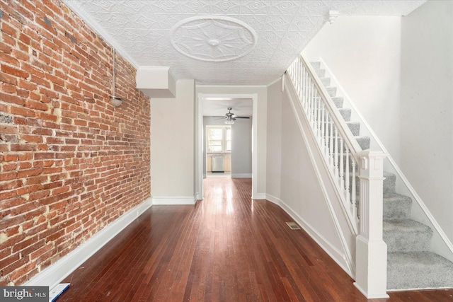 15 N Belnord Ave, Baltimore, MD 21224 - corridor with brick wall, hardwood / wood-style flooring, stairs, and an ornate ceiling