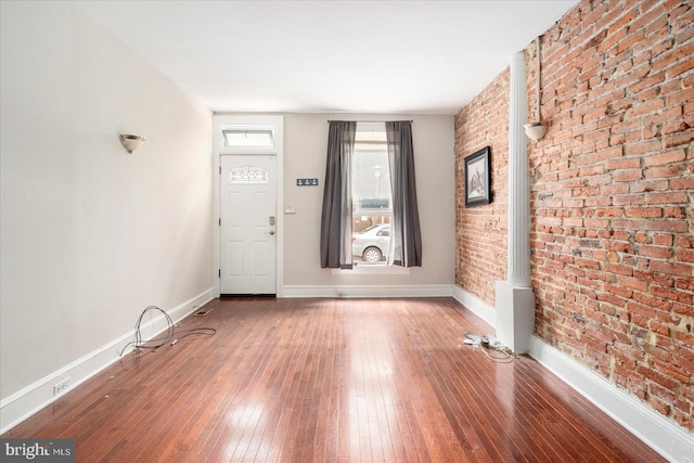 15 N Belnord Ave, Baltimore, MD 21224 - foyer entrance with brick wall and hardwood / wood-style floors