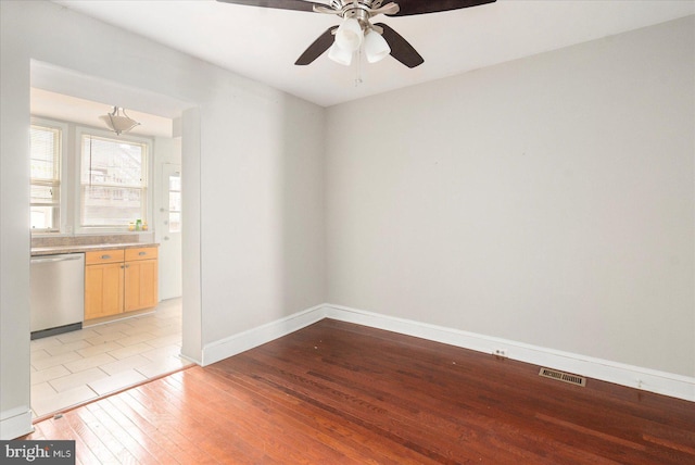 15 N Belnord Ave, Baltimore, MD 21224 - empty room with light wood-style floors and a ceiling fan