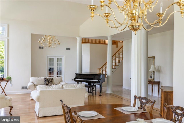 2630 Eagle Ln, Hellertown, PA 18055 - dining space featuring light wood finished floors, a chandelier, ornate columns, baseboards, and stairway