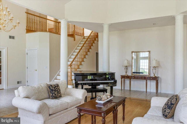 2630 Eagle Ln, Hellertown, PA 18055 - living room featuring ornate columns, a towering ceiling, stairway, wood finished floors, and baseboards