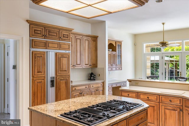 2630 Eagle Ln, Hellertown, PA 18055 - kitchen featuring black gas cooktop, paneled refrigerator, a ceiling fan, decorative backsplash, and brown cabinetry