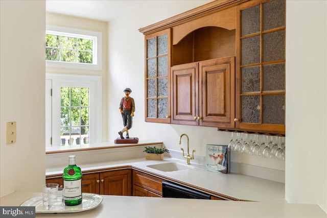2630 Eagle Ln, Hellertown, PA 18055 - kitchen featuring a sink, dishwasher, glass insert cabinets, light countertops, and brown cabinets