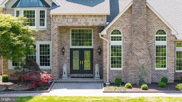 2630 Eagle Ln, Hellertown, PA 18055 - doorway to property featuring french doors, brick siding, a shingled roof, and a chimney
