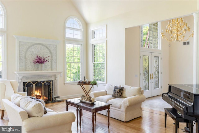 2630 Eagle Ln, Hellertown, PA 18055 - living area with high vaulted ceiling, a chandelier, french doors, a fireplace, and light wood finished floors