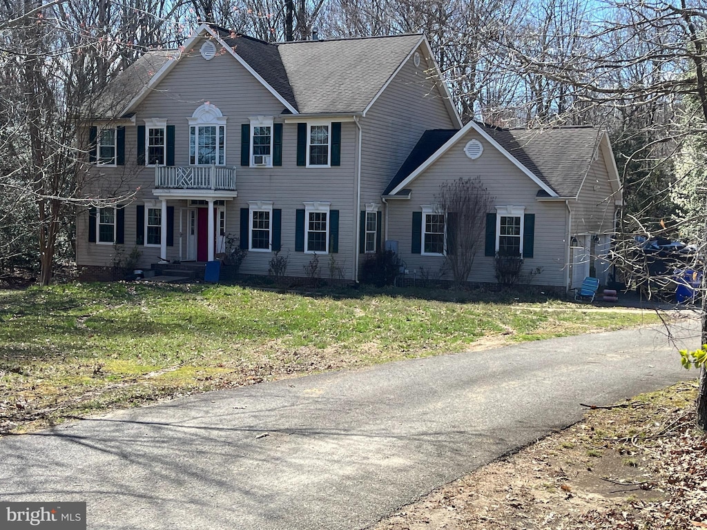 11375 Fair Fountain Farm Rd, La Plata, MD 20646 - colonial home featuring a balcony, a front lawn, and roof with shingles