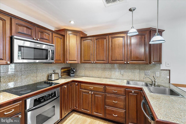 2919 Lexington Ct, Woodbridge, VA 22192 - kitchen with stainless steel appliances, tile countertops, pendant lighting, and decorative backsplash
