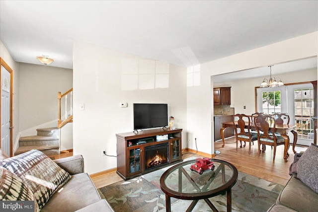 2919 Lexington Ct, Woodbridge, VA 22192 - living area with stairs, wood finished floors, baseboards, and a chandelier