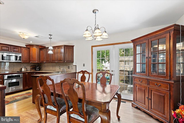 2919 Lexington Ct, Woodbridge, VA 22192 - dining area with a chandelier and light wood-style floors