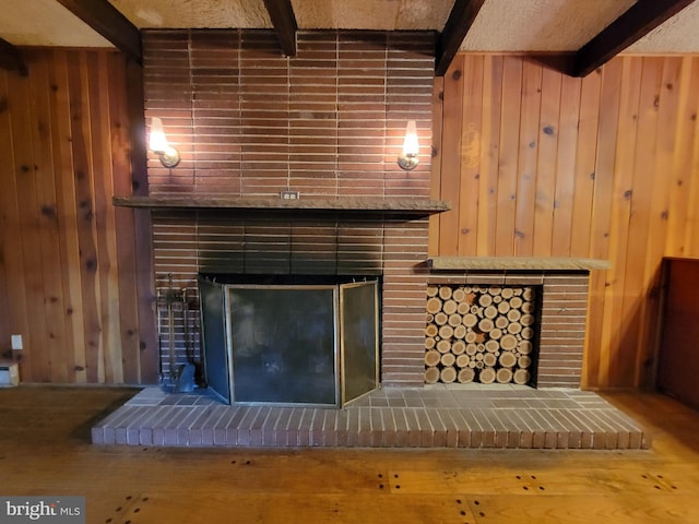 13337 Rowe Rd, Smithsburg, MD 21783 - detailed view of a fireplace, beam ceiling, wooden walls, and wood finished floors