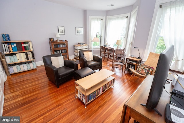 living room featuring wood finished floors and baseboards