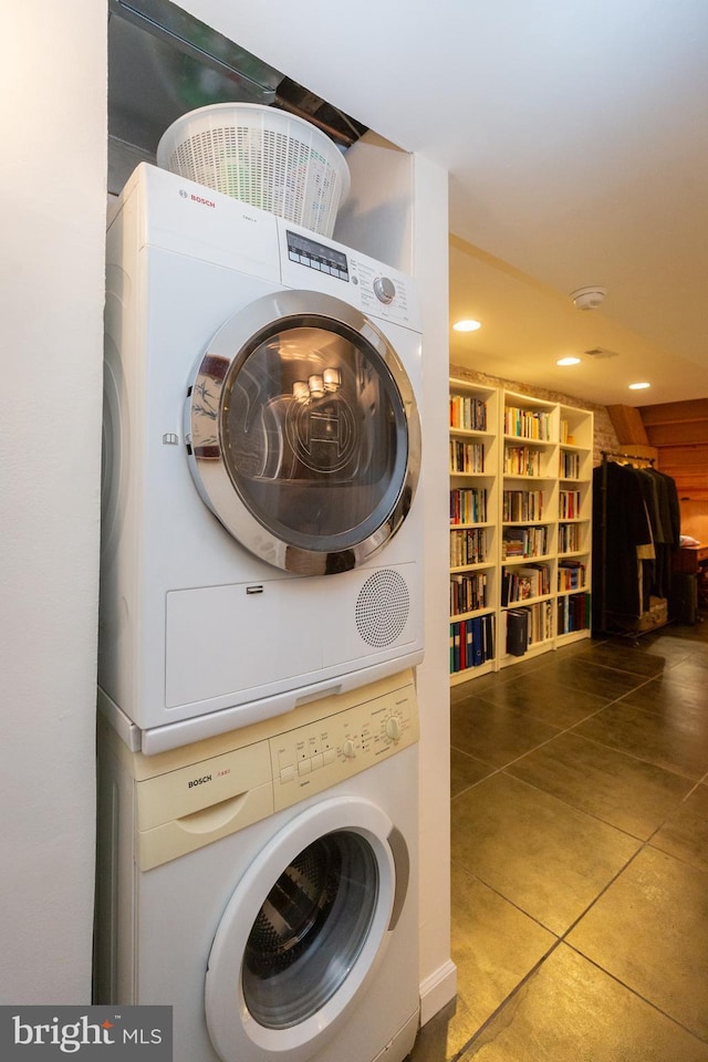 laundry room featuring stacked washer / drying machine, tile patterned floors, and recessed lighting