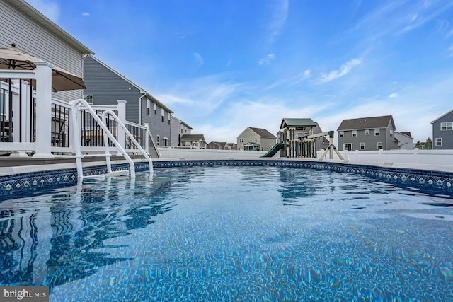 view of pool featuring fence
