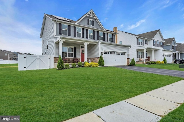 view of front of property featuring covered porch, a gate, asphalt driveway, stone siding, and board and batten siding