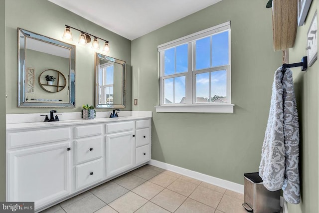 bathroom featuring baseboards, tile patterned floors, and double vanity