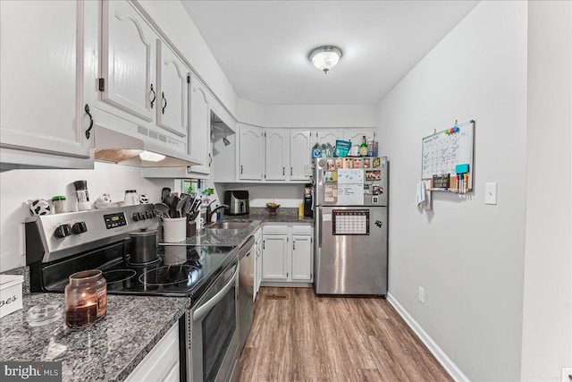 100 Cypress Dr, North East, MD 21901 - kitchen with stainless steel appliances, under cabinet range hood, light wood-style floors, a sink, and white cabinetry