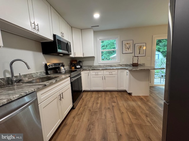 1410 Foxwood Ct, Annapolis, MD 21409 - kitchen featuring stainless steel appliances, a sink, white cabinetry, wood finished floors, and stone countertops