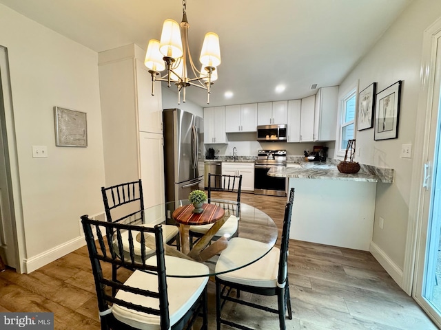 1410 Foxwood Ct, Annapolis, MD 21409 - dining space with a chandelier, baseboards, light wood-type flooring, and recessed lighting